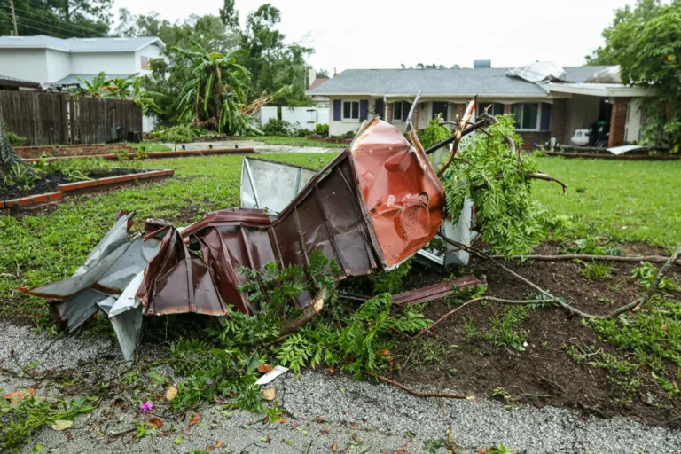 Hurricane damage insurance claim in Florida: storm debris in front of a damaged home